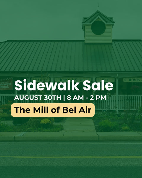 Promotional graphic for a sidewalk sale at The Mill of Bel Air, featuring a green-tinted photograph of the building facade with large white text and a yellow badge.