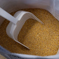 The Mill Starter Chicken Medicated Livestock Feed in a 50 lb bag with an Amprol scoop, designed for young chickens.