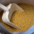 The Mill Layer Mash Chicken Feed in a 50 lb bag with a scoop, designed for poultry and chickens.