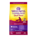 Small breed Wellness Pet Company turkey and oatmeal dry dog food in a 12 lb bag, designed for complete health and nutrition.