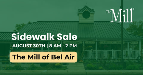 Promotional graphic for 'The Mill' featuring a green-tinted photograph of a historic mill building with text reading 'Sidewalk Sale' and 'August 30th | 8 AM - 2 PM' plus 'The Mill of Bel Air'.