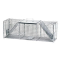 Havahart raccoon trap for pest control, metal cage with door, designed to safely trap raccoons and other small animals.